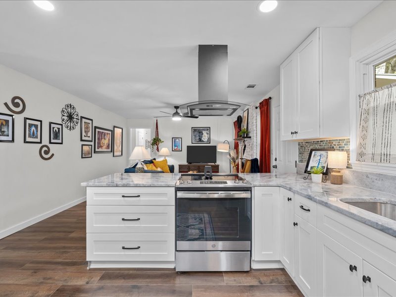 White open-concept kitchen at Artful Ansley looking into the living room
