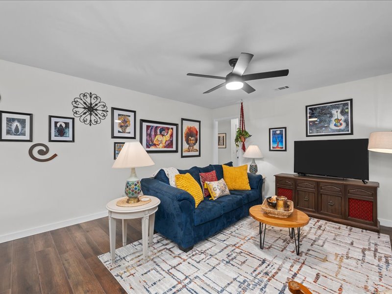 Living room gallery wall filled with artwork at Artful Ansley