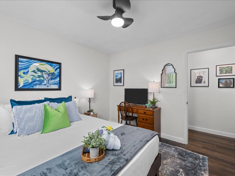Bedroom with framed artwork displayed throughout the room