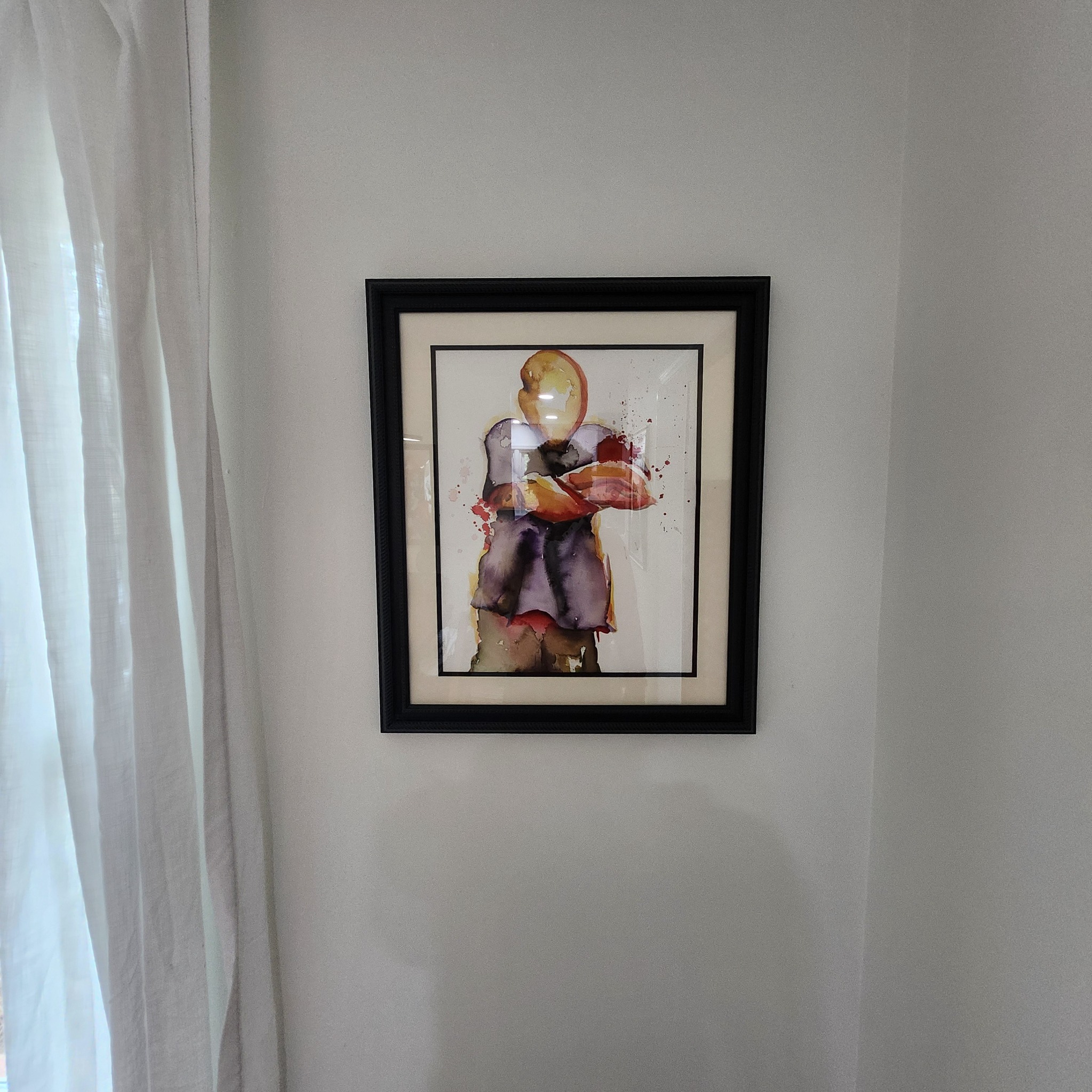 Framed watercolor figure displayed at Artful Ansley