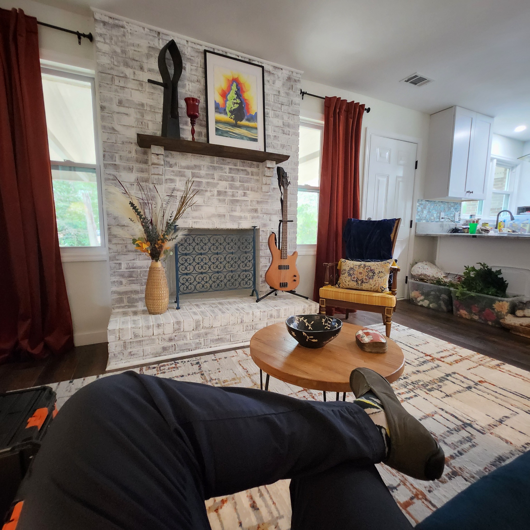 Living area fireplace with artwork
